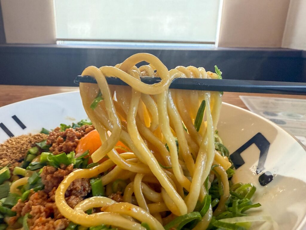 しっかりと混ぜ合わせて持ち上げた「辛肉まぜそば」。具材と麺の絡み具合が絶妙。